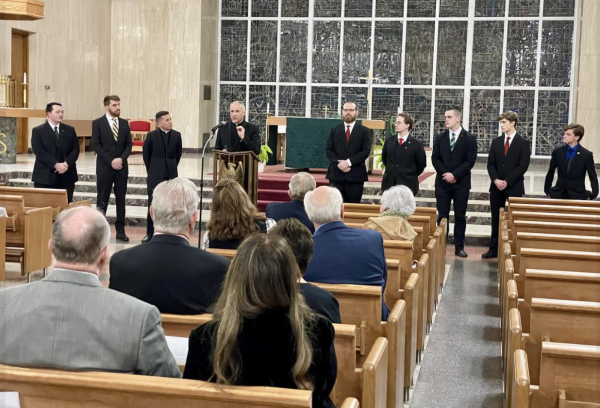The Very Reverend Scott W. Jabo, Rector of St. Mark Seminary, addresses invited guests from the Serra Club of Erie inside the St. Mark Seminary chapel on January 10, 2024, while the seven current seminarians look on (l-r): Tyler Niebauer 27, Michael Liebler 26, The Reverend David M. Renne (Vice-Rector), Michael Geary 24, Noah Marangoni 25, Joseph Preston 25, Anthony Frisina 27, and Dale Hyland 25. 